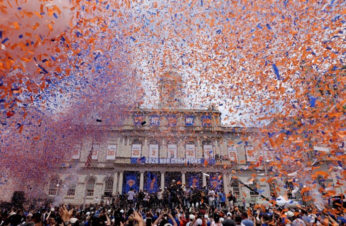 Miles de aficionados celebran el campeonato de los New York Knicks durante el desfile de campeones en Manhattan entre confeti naranja y azul.
