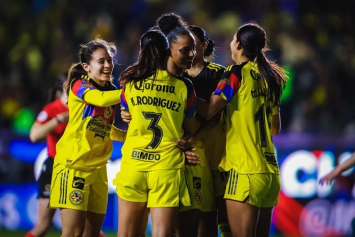 Jugadoras de América Femenil celebran juntas durante un partido.